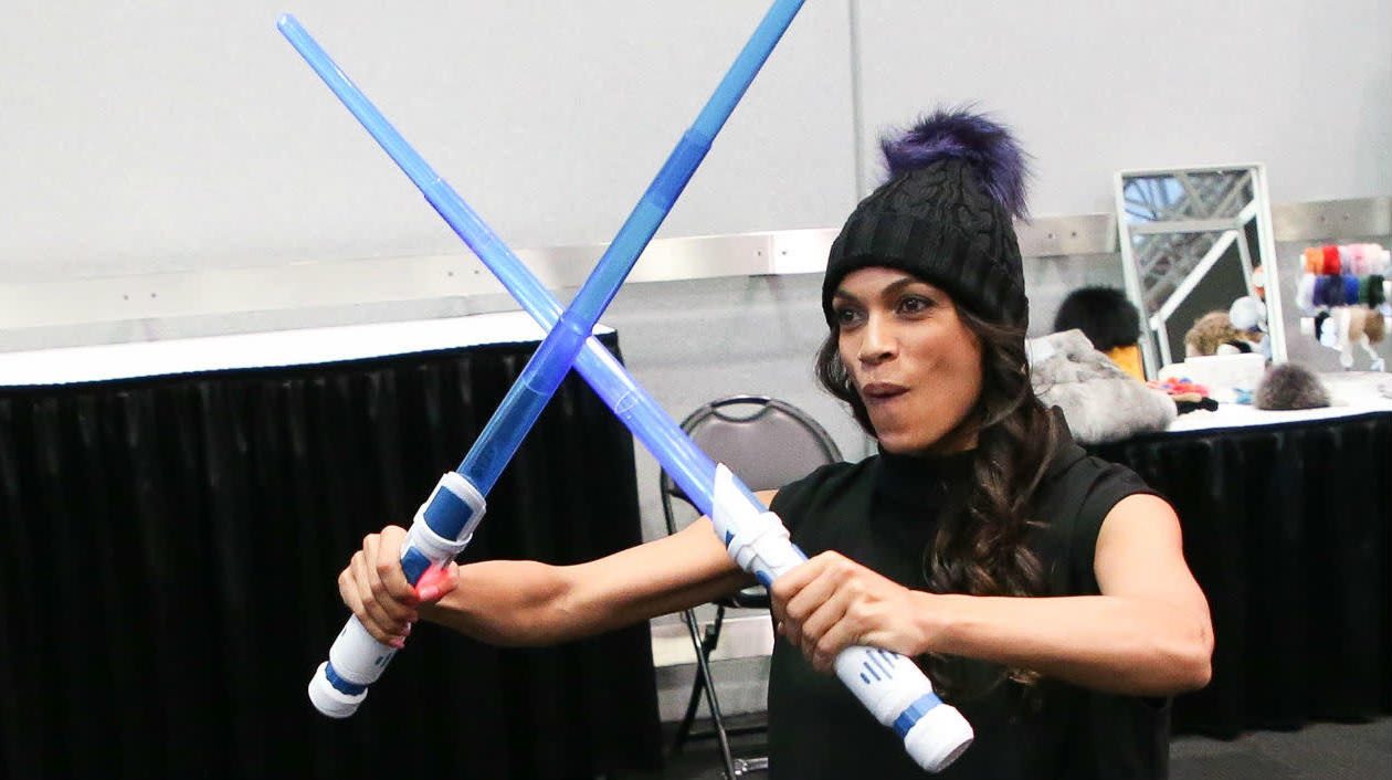 Rosario Dawson Two Toy Blue Lightsabers
