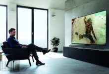 man in suit watches hd tv