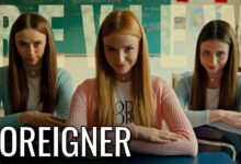 Video Movie Review: FOREIGNER (2025): Its Sharpest Cultural Satire Survives an Underdeveloped Finale